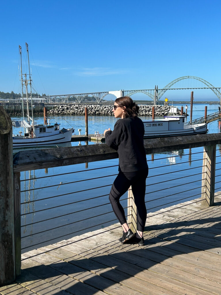 Me standing on the docks in Newport, OR looking at the boats